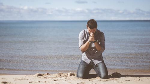 Man praying to God for more holiness